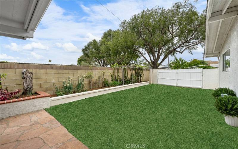 Portion of backyard - Optional RV Parking, Pool Size Space or a beautiful Lawn - more of the backyard is not visible in photo.  Lot provides large side yard(s) too.  (Grass has been graphically enhanced)