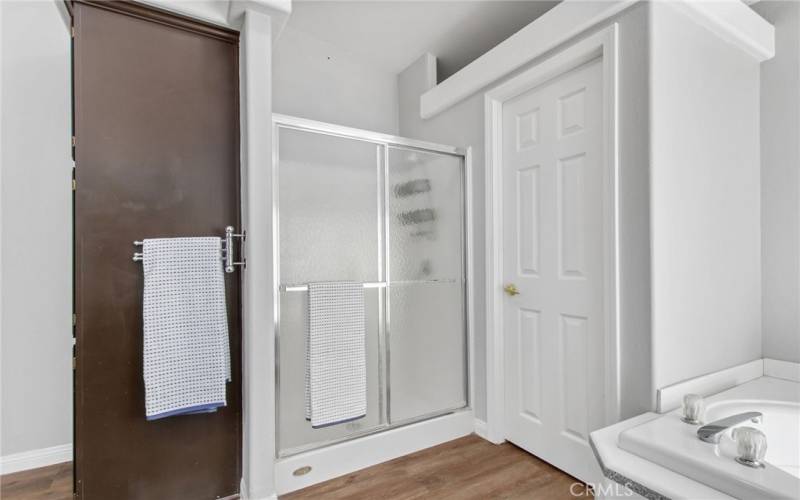 Walk in shower & built-in linen closet in the primary bathroom