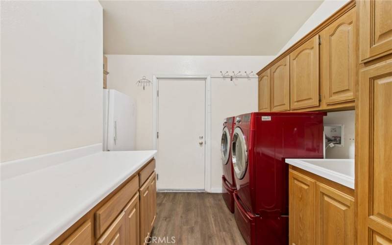 Huge laundry room with sink and direct garage access.