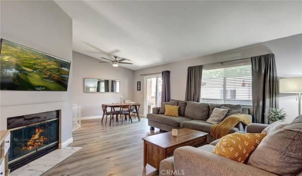 Living Space has Cathedral Ceilings and lots of natural light. Laminate Flooring throughout the home.Image on tv screen & fire have been digitally added.