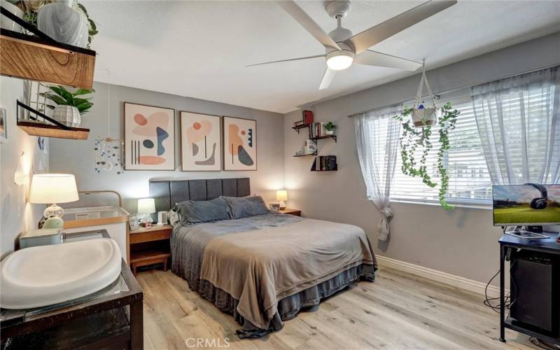 Primary Bedroom with ceiling fan and large window