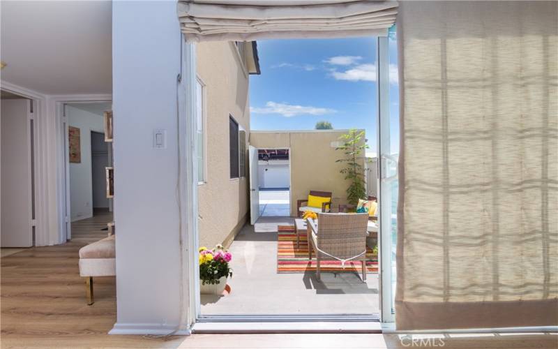Sliding Glass door open to patio and garage access