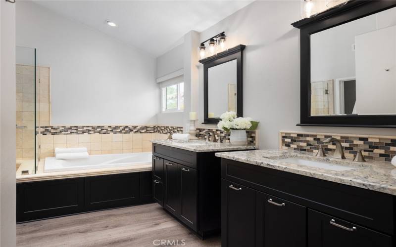 The primary bathroom offers dual vanity with quartz countertops and a walk-in closet.