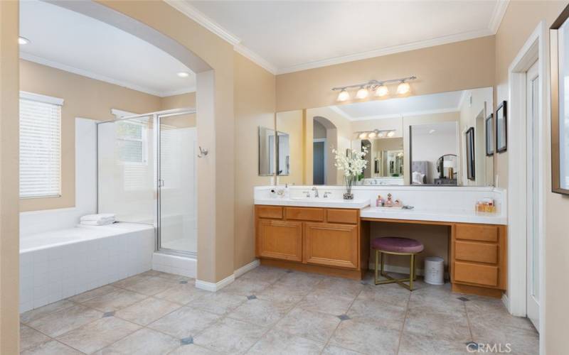 The primary suite bathroom features dual vanities and two walk-in closets.