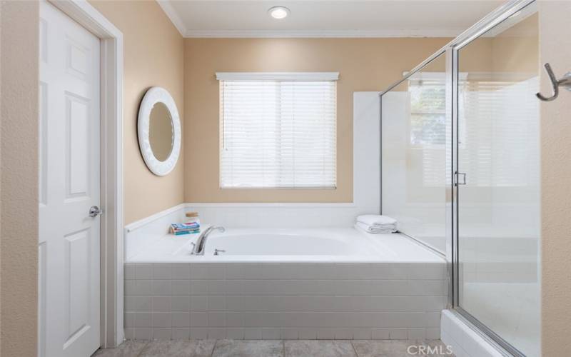 Luxurious en-suite bathroom with a tub and separate walk-in shower.