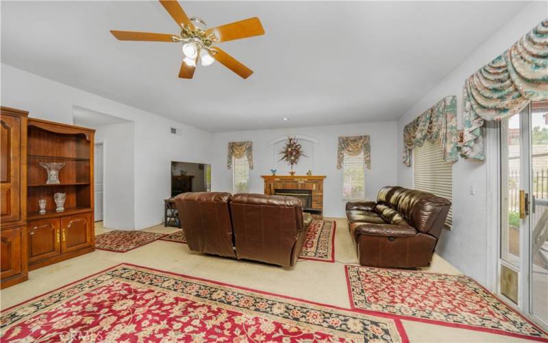 Family room/living room with fireplace. Opens up to kitchen and pool/patio/backyard