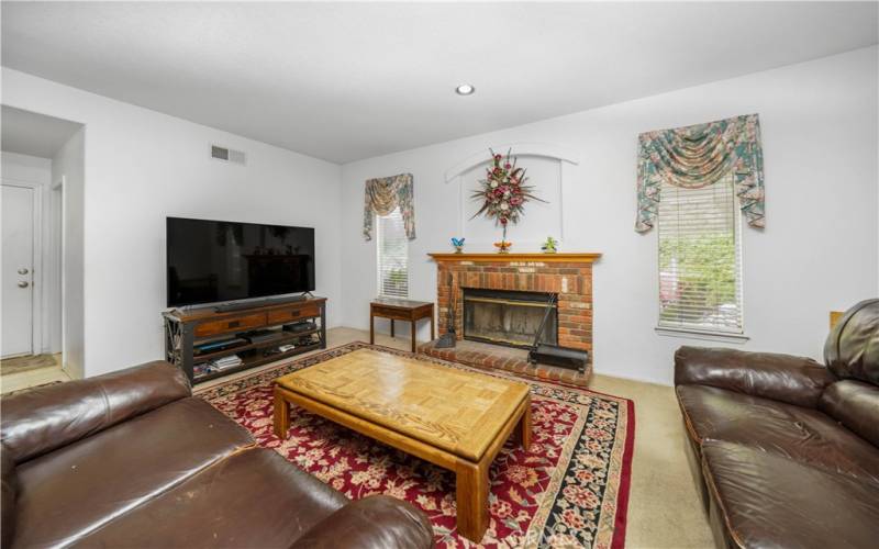 Family room/living room with fireplace. Opens up to kitchen.