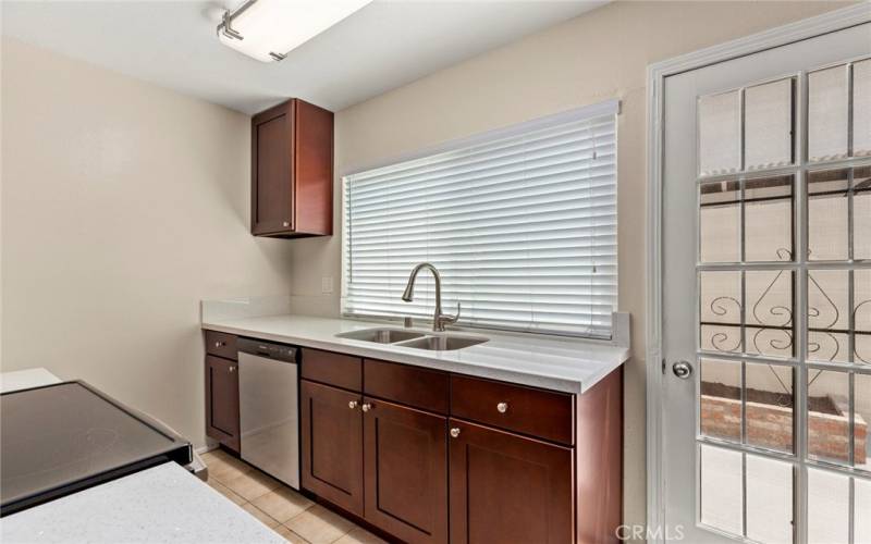 The kitchen features include a newer dishwasher, contemporary stainless steel sink and faucet, white blinds...*Pictures are from previous listing but comments are current.