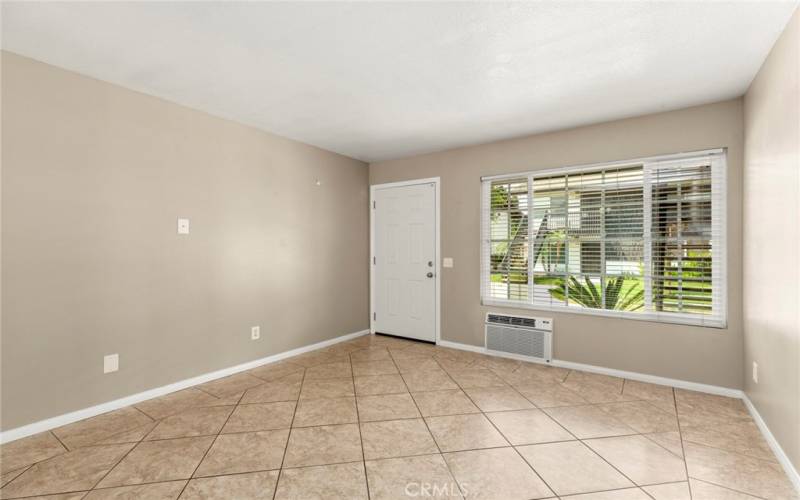 The large living room space features contemporary paint color with white trim and neutral tile flooring and newer updated dual pane windows throughout the property to aid in the energy efficiency in the home....*Pictures are from previous listing but comments are current.