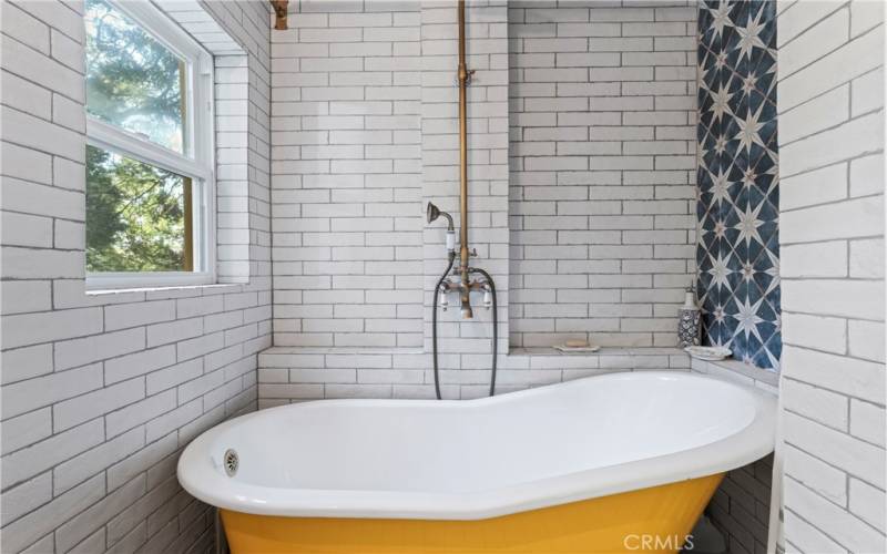 Relaxing clawfoot tub with optional shower and candle shelf