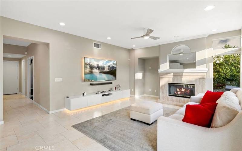 Family room with a built-in floating media center and a fireplace.