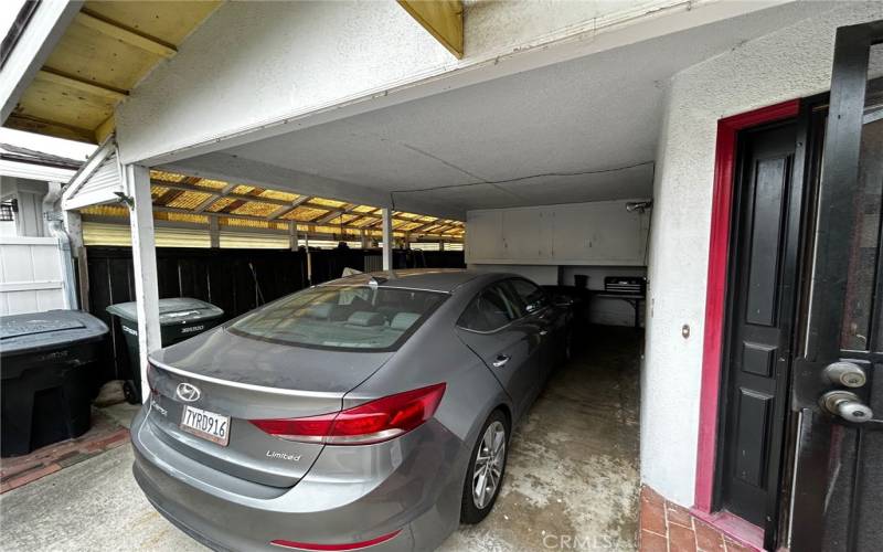 Covered carport with room on drive for 2 car.