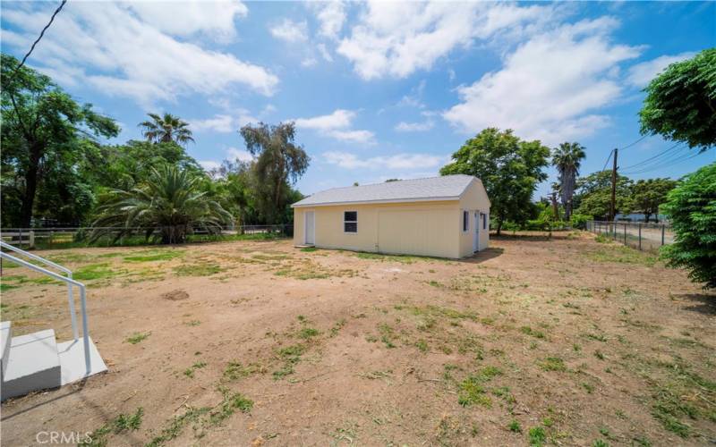 Behind the home is a middle yard and the bonus room (right) and attached 2-car garage (left) all clear, clean and ready for you!