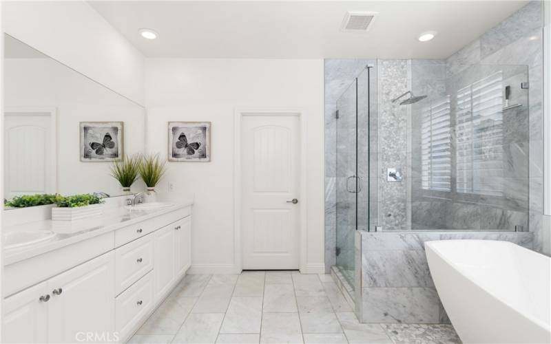 This fully remodeled primary bathroom looks like a high end spa!