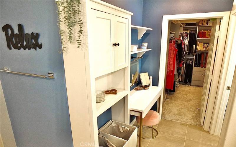 En-suite Primary with custom built out closet, vanity station w/ storage, soaking tub, walk in shower and dual quartz sinks