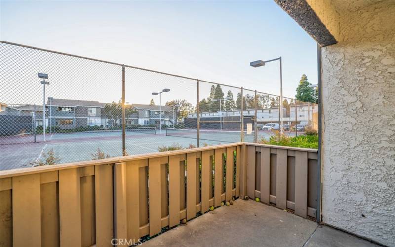 Balcony view with tennis courts