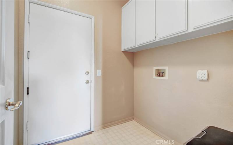 Convenient inside laundry room with storage cabinets!