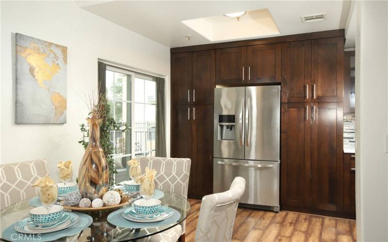 Refrigerator and surrounding pantry cabinets with roll-outs