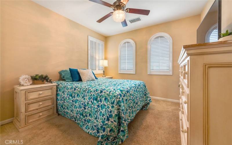 Guest Bedroom has Plantation Shutters and decorative Fan/Light