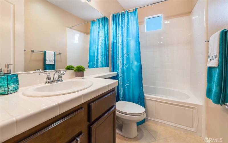 Well-lighted Guest Bedroom has a shower/tub combo for 