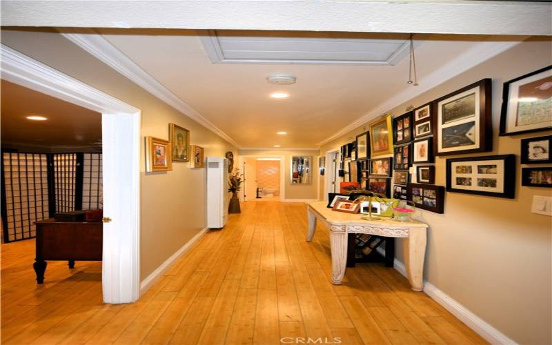 Gorgeous floors in well lit and wide hallway