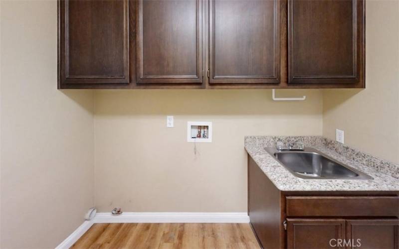 Downstairs Laundry has Stainless Sink with Granite Countertop and Direct Access to the Garage