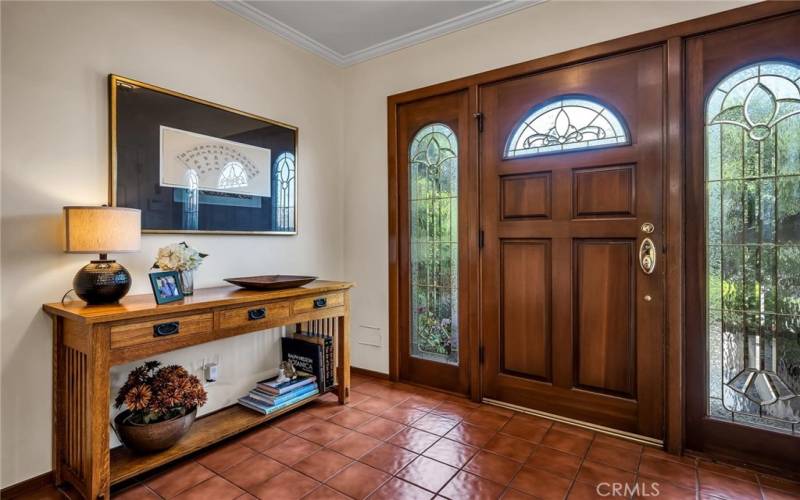A solid wood stained glass door with sidelites welcomes you into the foyer