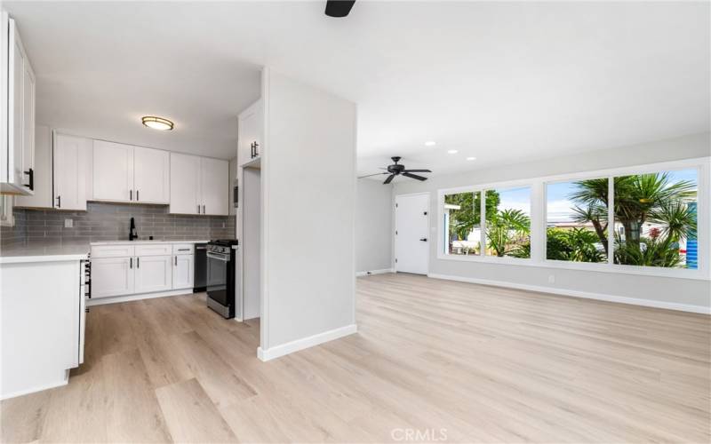 The efficient layout flows into a well appointed kitchen, with plenty of white shaker style cabinets, quartz countertops, matte black finishes and new stainless steel appliances!