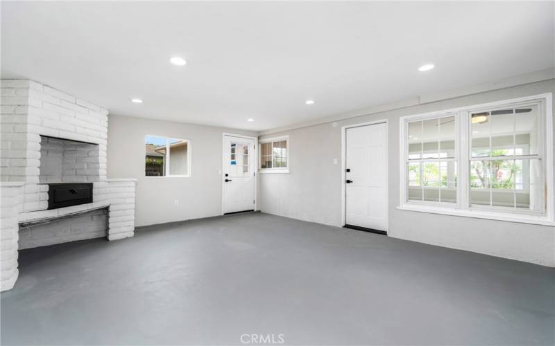 Enjoy painted concrete floors, recessed lighting, and a brick fireplace that has BBQ/pizza oven potential!