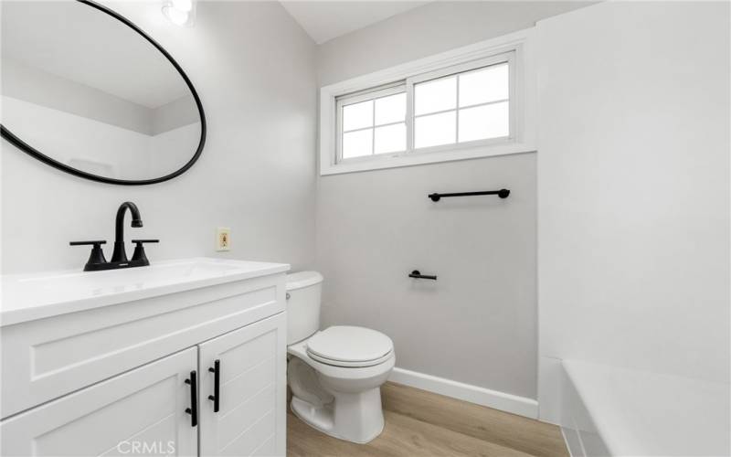 Across the hall there is a full bath with a refreshed shower tub and new vanity and fixtures!