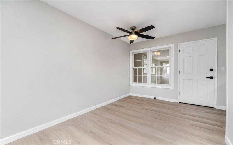 Open to the kitchen is a dining area with a ceiling fan and a door to an enclosed patio!