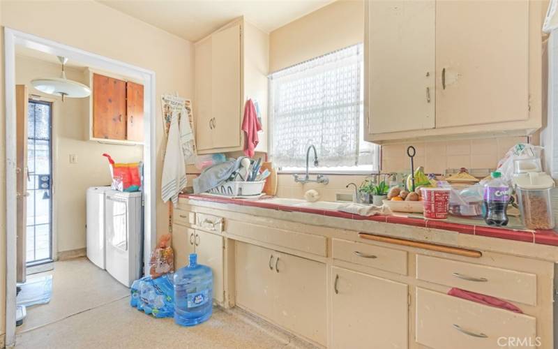 Back unit Galley Kitchen cabinet and sink with back door entrance.