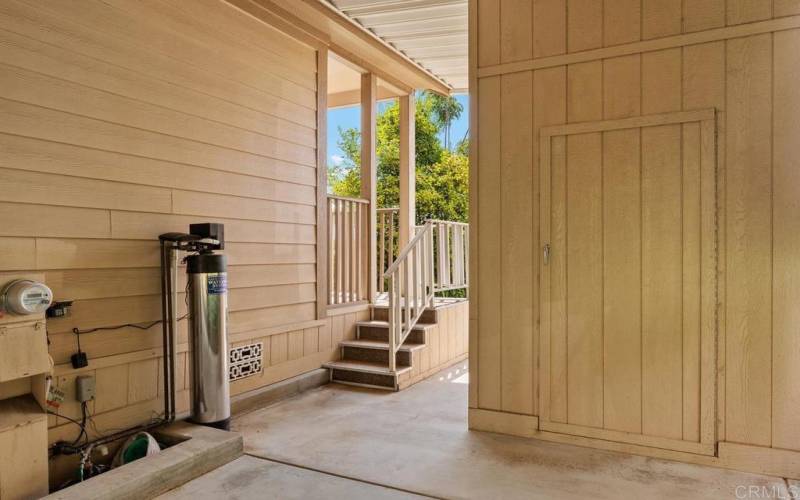 Notice the stairs from the rear deck down to the carport and shed.