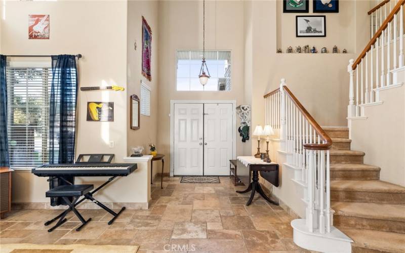 Natural light and an open staircase highlight this foyer entry.