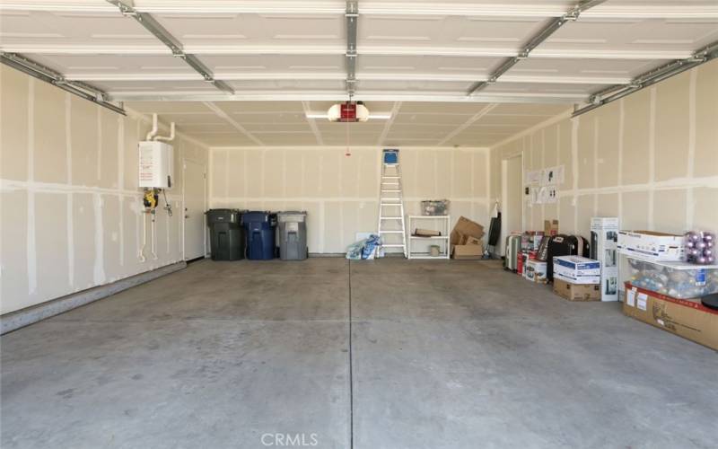Garage is clean with it's sheetrocked walls.