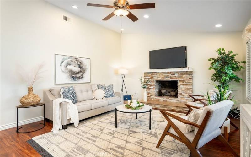 Living room w/vaulted ceilings, recessed lights, and romantic fireplace!