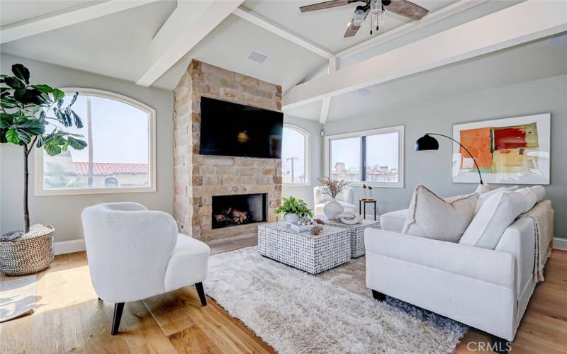 Living room features high ceilings, fireplace and expansive views.
