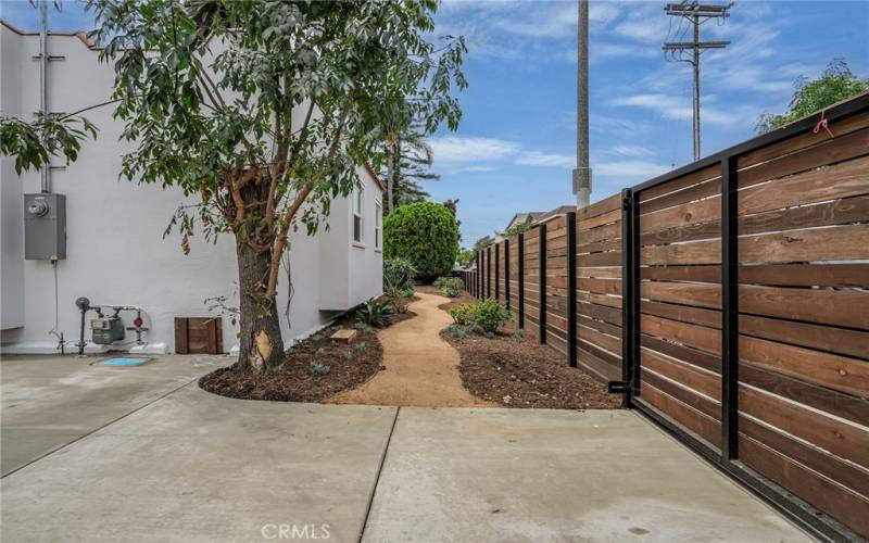 A beautiful look down the interior side yard with privacy fencing.