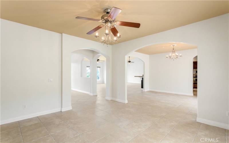 View of the open floor plan from the formal living room into dining room and family living area.