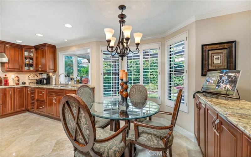 Enjoy a light and bright breakfast nook with large windows overlooking the manicured backyard.