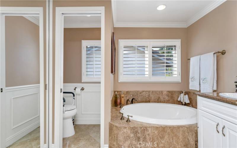 Primary Bath  with beautiful stone and millwork.