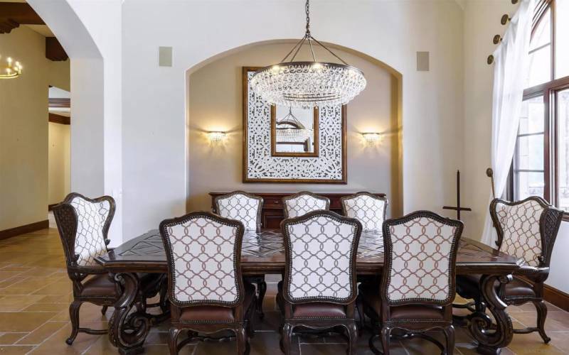 Gorgeous formal dining room furnished with large table and designer chairs.