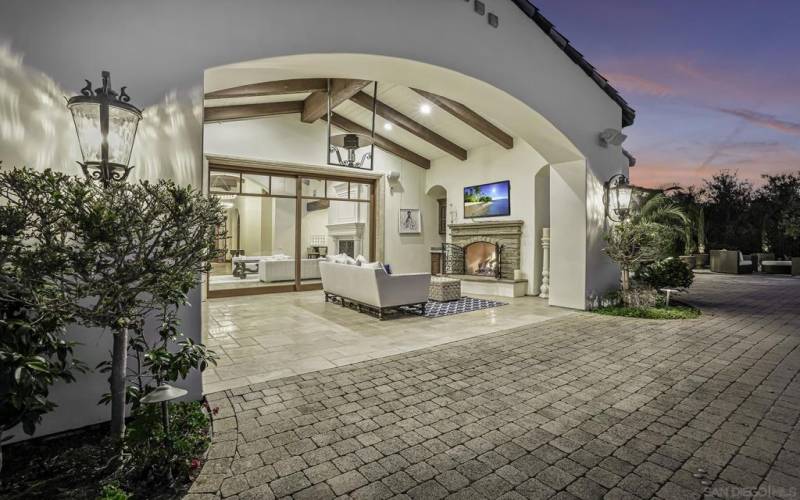 Great outdoor living room with fireplace and heater above.