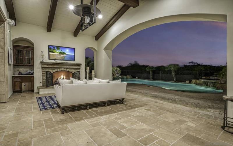 Easy access outside to this outdoor covered living room directly from family room