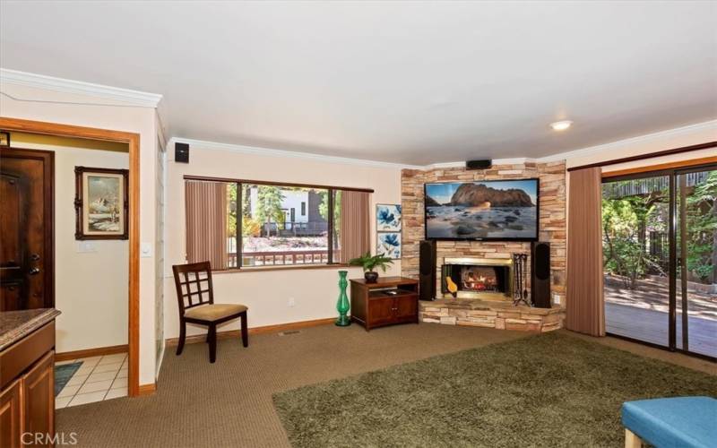 Gameroom with Fireplace and Slider to the Deck and Backyard