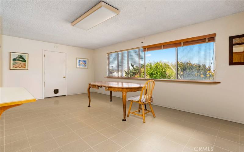 Dining area with ocean view. Photo has been virtually edited to remove seller's personal property.