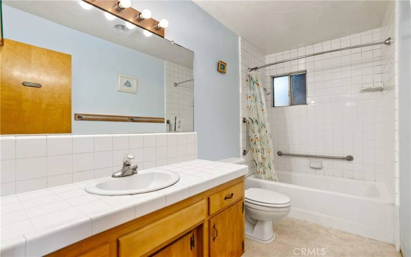 Bathroom off hallway. Photo has been virtually edited to remove seller's personal property.
