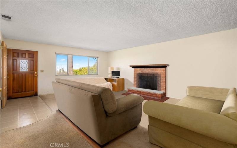 Living room with ocean view. Photo has been virtually edited to remove seller's personal property.