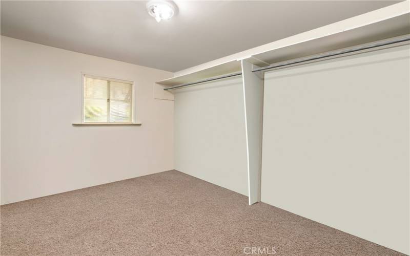 Walk-in closet off primary bedroom. Photo has been virtually edited to remove seller's personal property.
