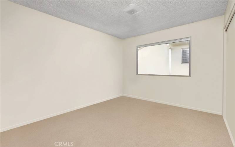 Bedroom off hallway. Photo has been virtually edited to remove seller's personal property.